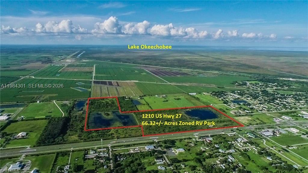 An aerial view shows a large, rectangular plot of land outlined in red near a highway — 1210 N U S Highway 27, Moore Haven FL 33471, MOORE HAVEN, FL