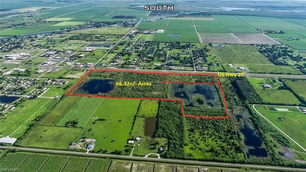 This aerial view shows a large, undeveloped parcel of land outlined in red near a highway — 1210 N U S Highway 27, Moore Haven FL 33471, MOORE HAVEN, FL
