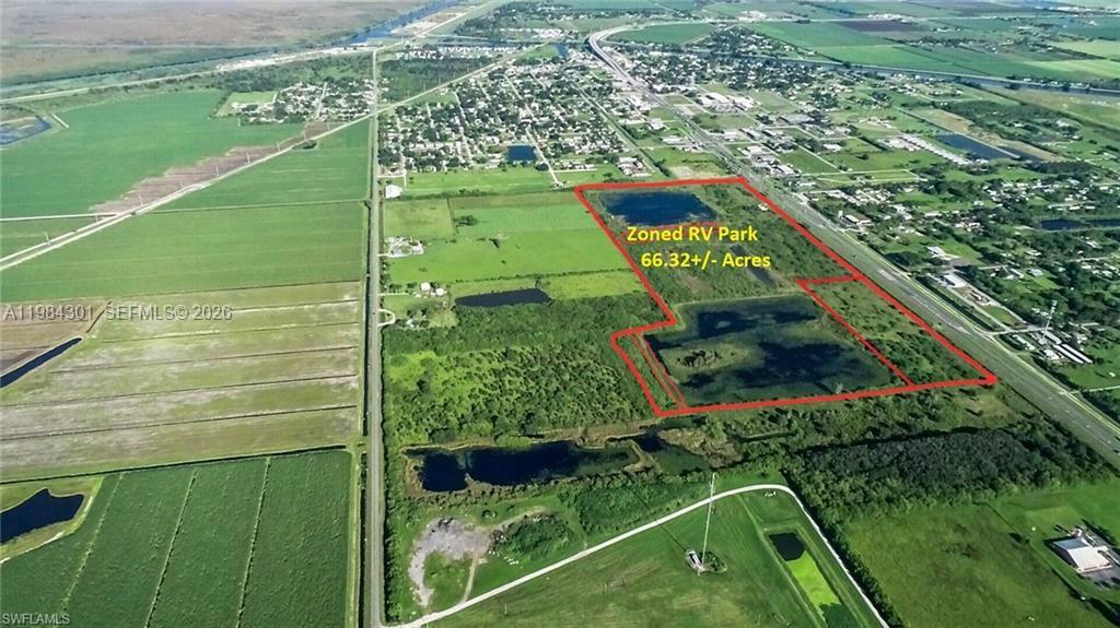 An aerial view shows a large, undeveloped plot of land outlined in red — 1210 N U S Highway 27, Moore Haven FL 33471, MOORE HAVEN, FL