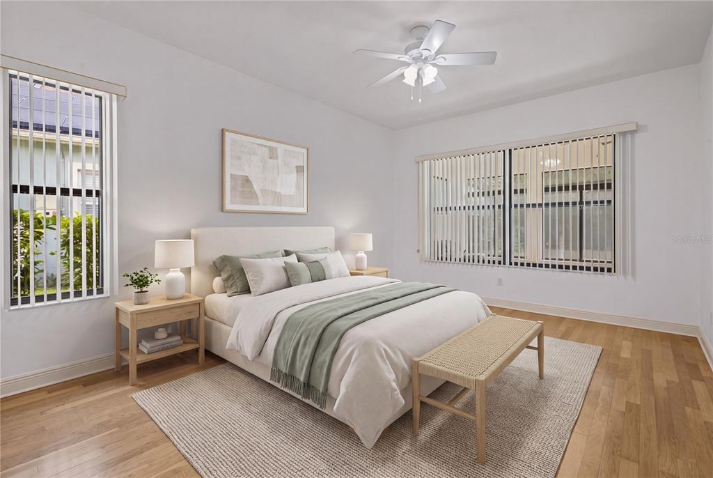 A living room features a white sofa, two light blue armchairs, and large sliding glass doors — 14834 MAN O WAR DRIVE, ODESSA, FL