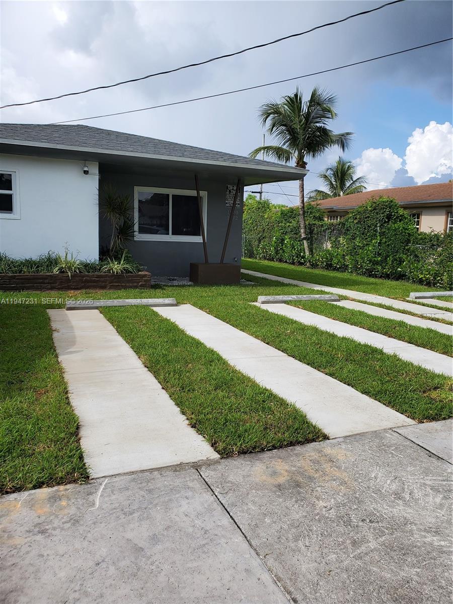 The exterior of a single-story house features a concrete driveway with grass strips — 1170 NE 111th St # 1170, Miami FL 33161, MIAMI, FL