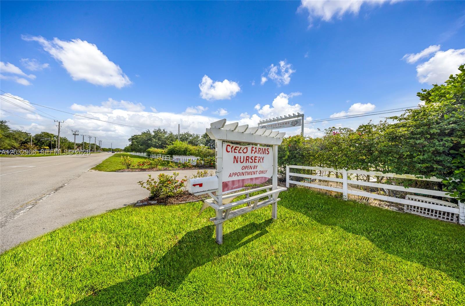 A white wooden sign for Cielo Farms Nursery stands on a grassy lawn beside a road — 4680 SW 148th Ave, Southwest Ranches FL 33330, SOUTHWEST RANCHES, FL