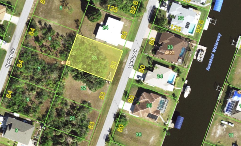 This is an aerial map showing a vacant lot highlighted in yellow — 9413 SPRING CIRCLE, PORT CHARLOTTE, FL