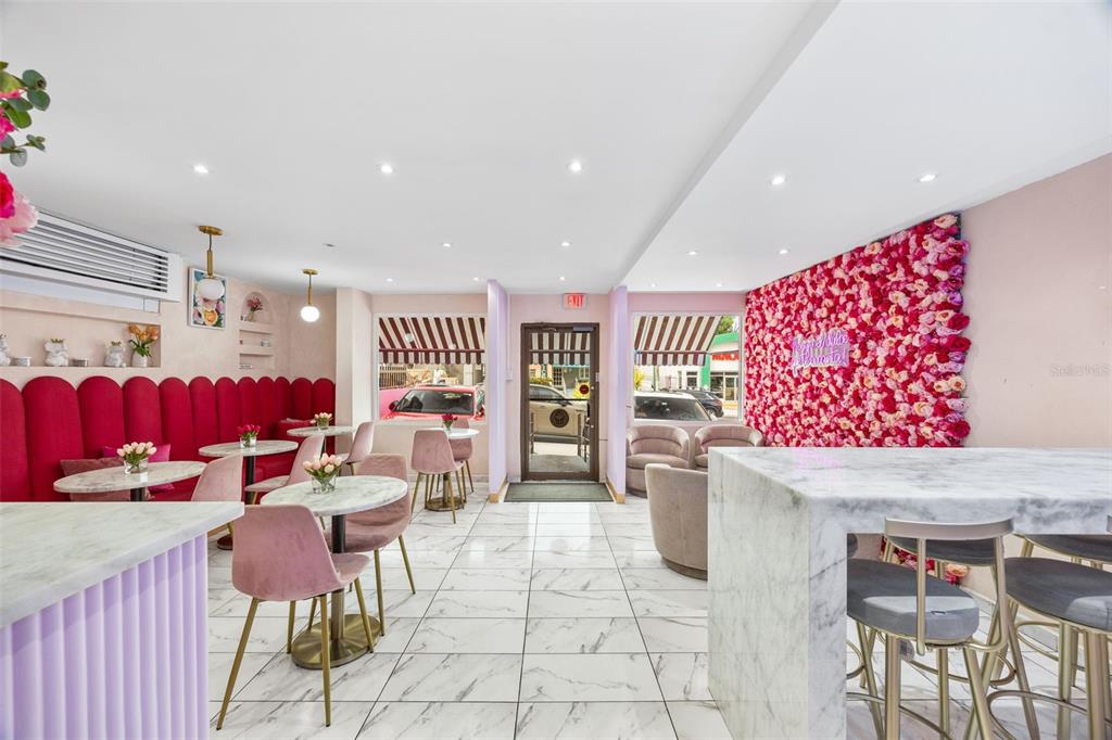 A commercial interior features marble floors, pink velvet seating, and a floral accent wall — 156 WINSTON CHURCHILL AVENUE, SAN JUAN, PR