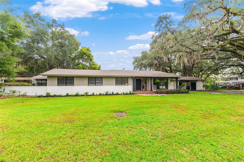 A single-story house with a white brick base, gray siding, and a large front lawn — 1237 SE 8TH STREET, OCALA, FL