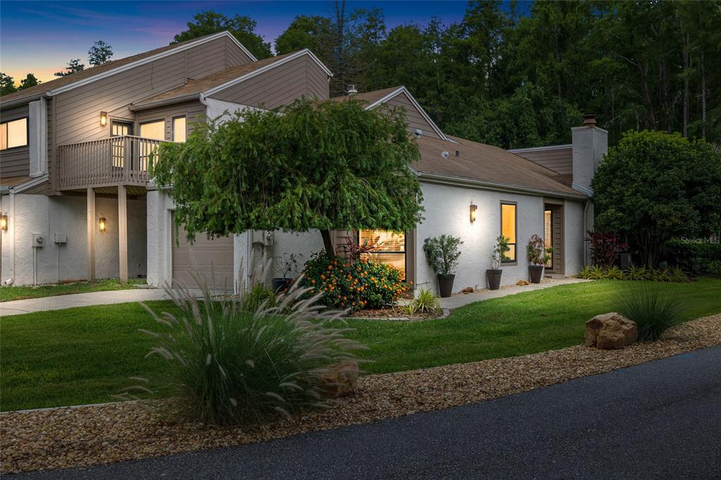 A two-story house with a beige exterior, a balcony, and a landscaped front yard — 11520 GALLERIA DRIVE, TAMPA, FL
