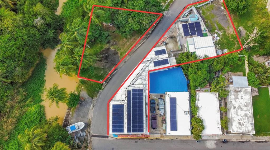 An aerial view shows two adjacent properties with solar panels, a road, and a river — 0 TABLAZO UNIT 536, FAJARDO, PR