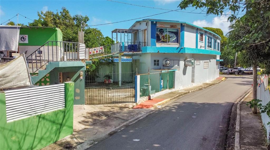 A two-story building with a blue trim, exterior staircase, and a fenced yard — 0 TABLAZO UNIT 536, FAJARDO, PR