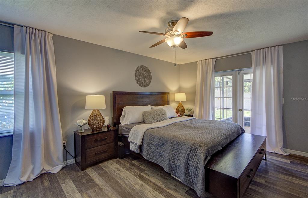 A dining area with a wooden table, white chairs, and a ceiling fan — 13222 PINE CREEK CIRCLE, RIVERVIEW, FL