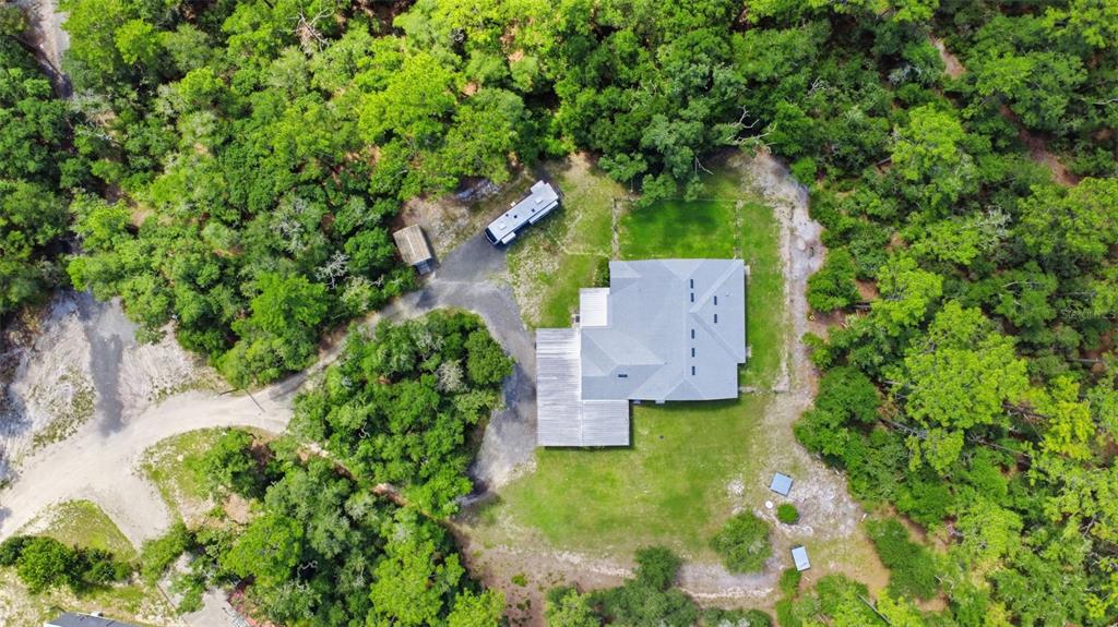 An aerial view shows a house with a gray roof, a driveway, and a parked RV — 922 VOLUSIA TIMBER COURT, LAKE HELEN, FL