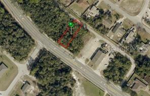 An aerial view shows a rectangular plot of land outlined in red near a road — 728 FORT SMITH BOULEVARD, DELTONA, FL