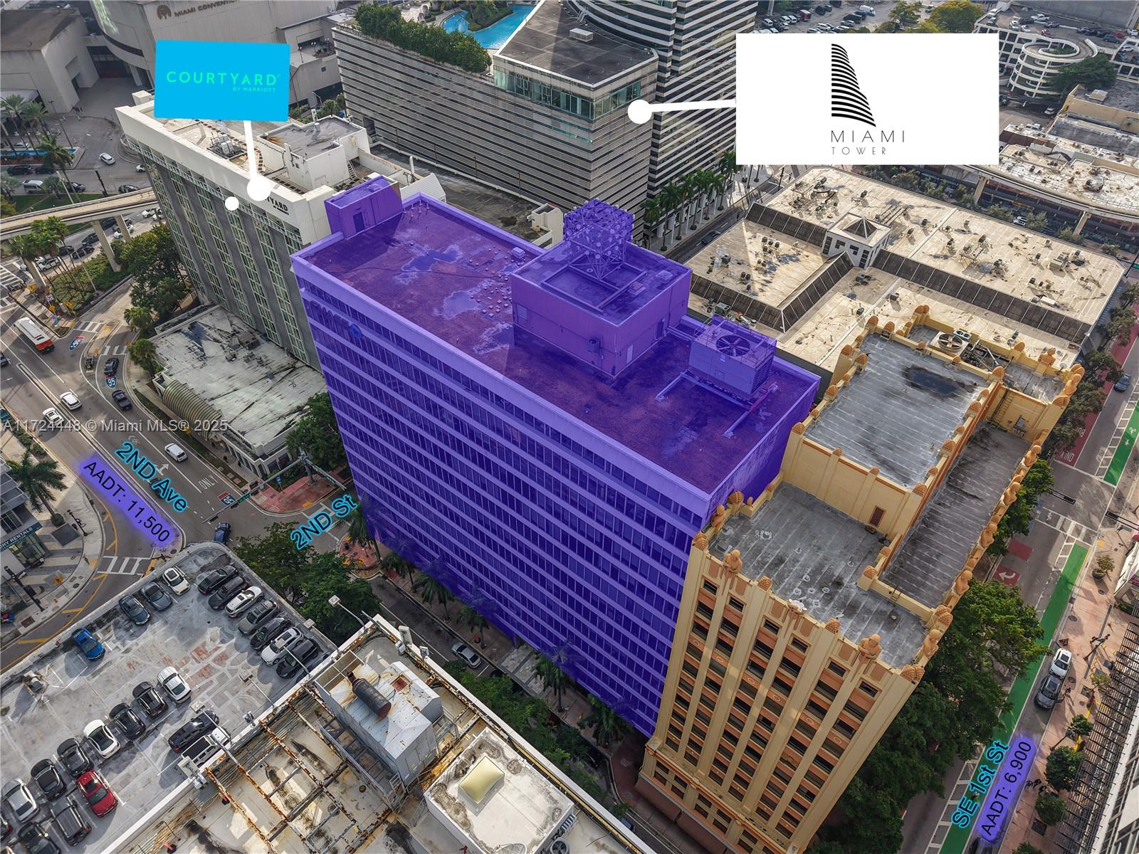 An aerial view shows a purple-highlighted building situated at a city street intersection — 150 SE 2nd Ave # 103, Miami FL 33131, MIAMI, FL