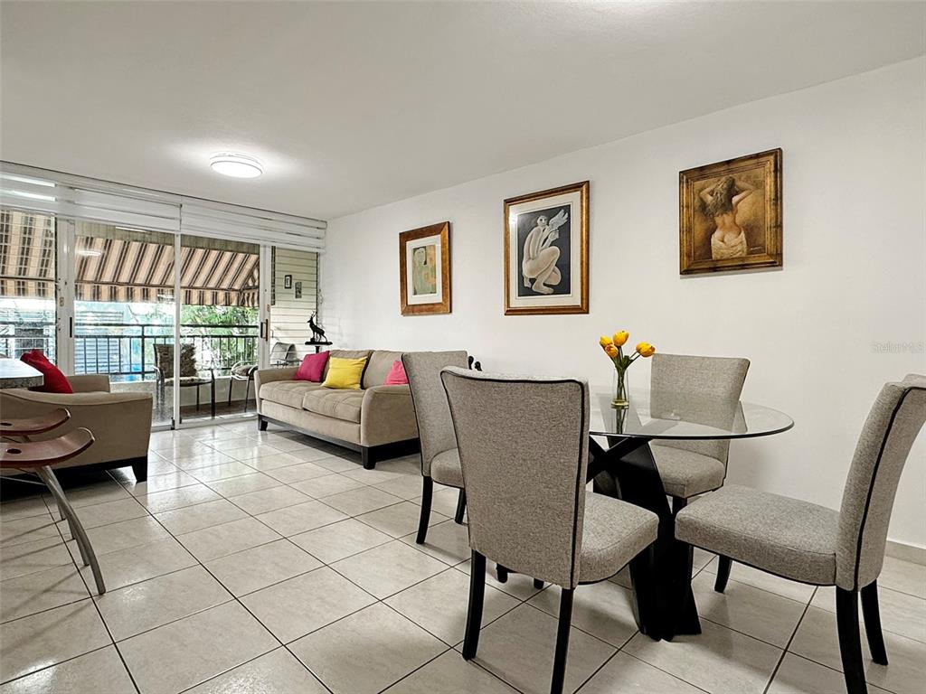 A living and dining area features tile floors, a glass table, and a beige sofa — Cond Valles de Torrimar BLVD. PEDRO FULLANA VIRELLA UNIT D-212, GUAYNABO, PR
