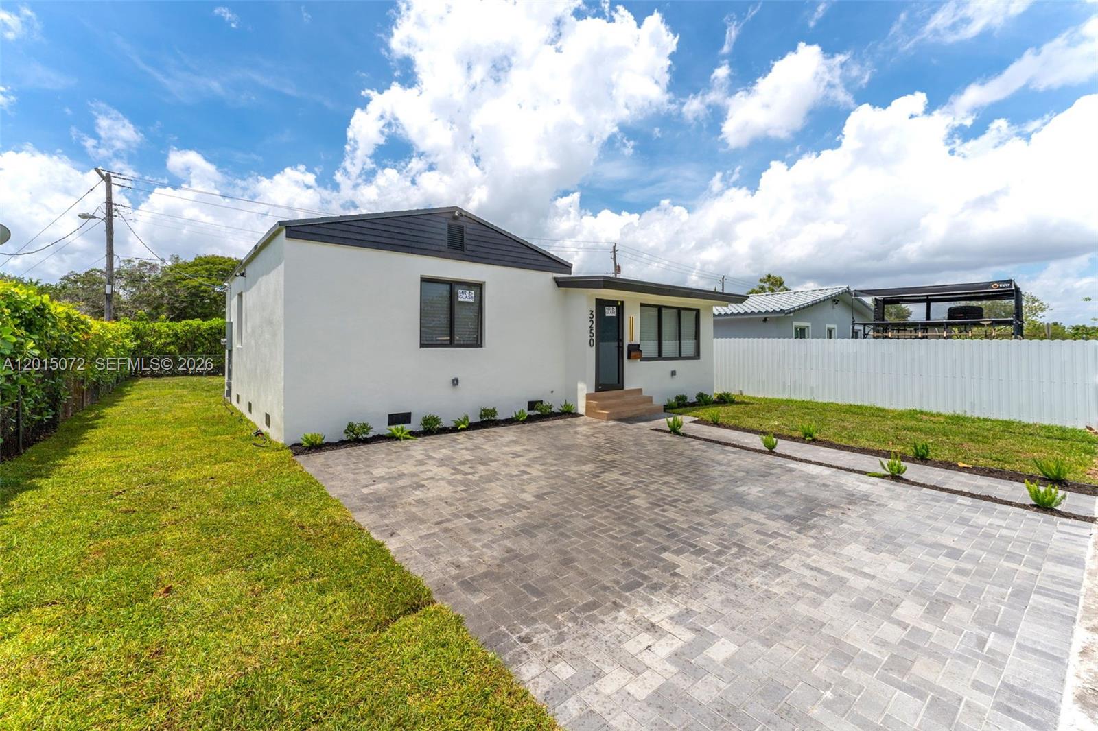 A single-story house with a white exterior, dark trim, and a paved driveway — 3250 SW 68th Ave, Miami FL 33155, MIAMI, FL