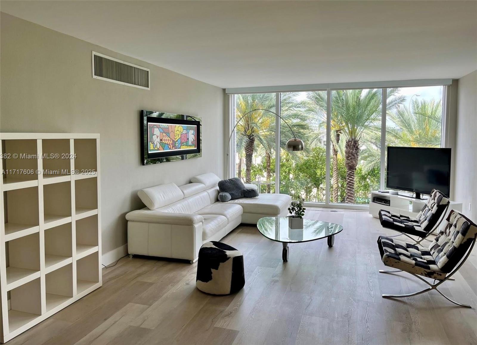 A living room features a white sectional sofa, glass coffee table, and floor-to-ceiling windows — 10275 Collins Ave # 331, Bal Harbour FL 33154, BAL HARBOUR, FL