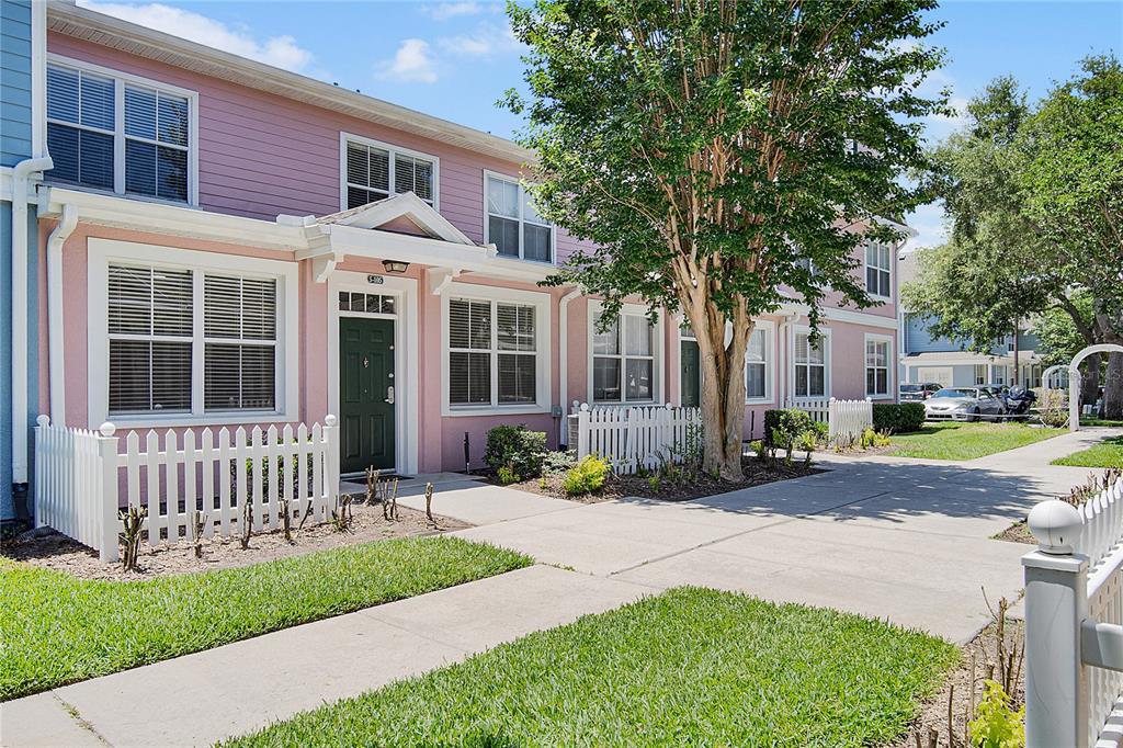 A kitchen features white cabinets, stainless steel appliances, and a marble-patterned island with a sink — 4007 VENETIAN BAY DRIVE UNIT 105, KISSIMMEE, FL