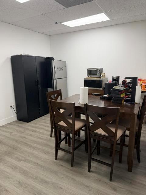 A breakroom features a dark cabinet, a refrigerator, a microwave, and a wooden dining set — 2560 N Powerline Road # 201, Pompano Beach FL 33060, POMPANO BEACH, FL