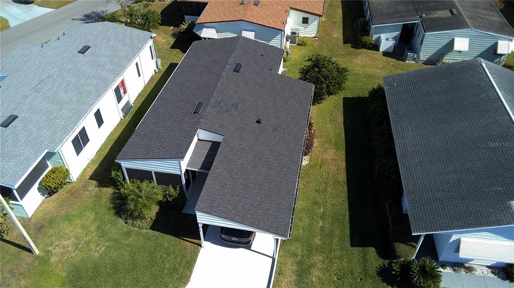An aerial view shows a house with a dark shingled roof and a carport — 4816 GOLDENVIEW LANE, LAKELAND, FL