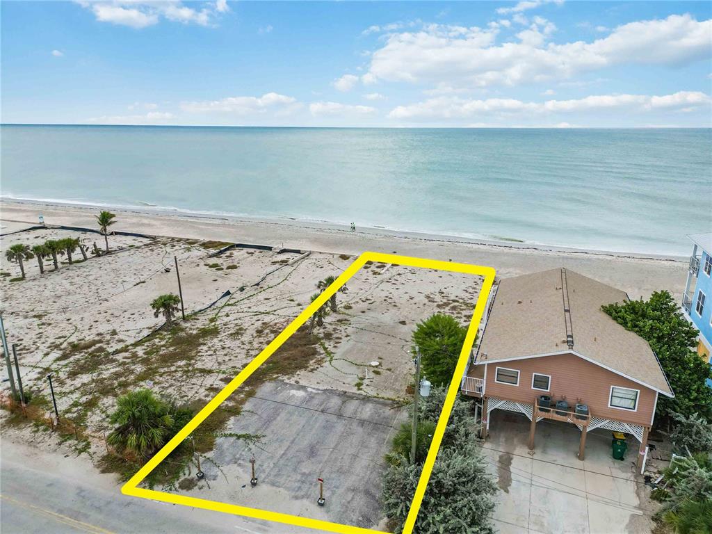 An aerial view shows a vacant, rectangular beachside lot outlined in yellow next to a house — 1120 SHORE VIEW DRIVE UNIT D, ENGLEWOOD, FL