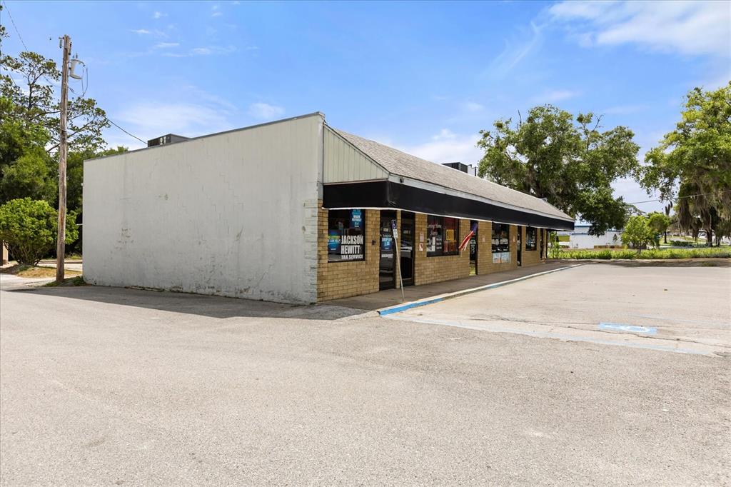 A single-story commercial building with a brick facade and a black awning — 5053 SE ABSHIER BLVD BOULEVARD, BELLEVIEW, FL