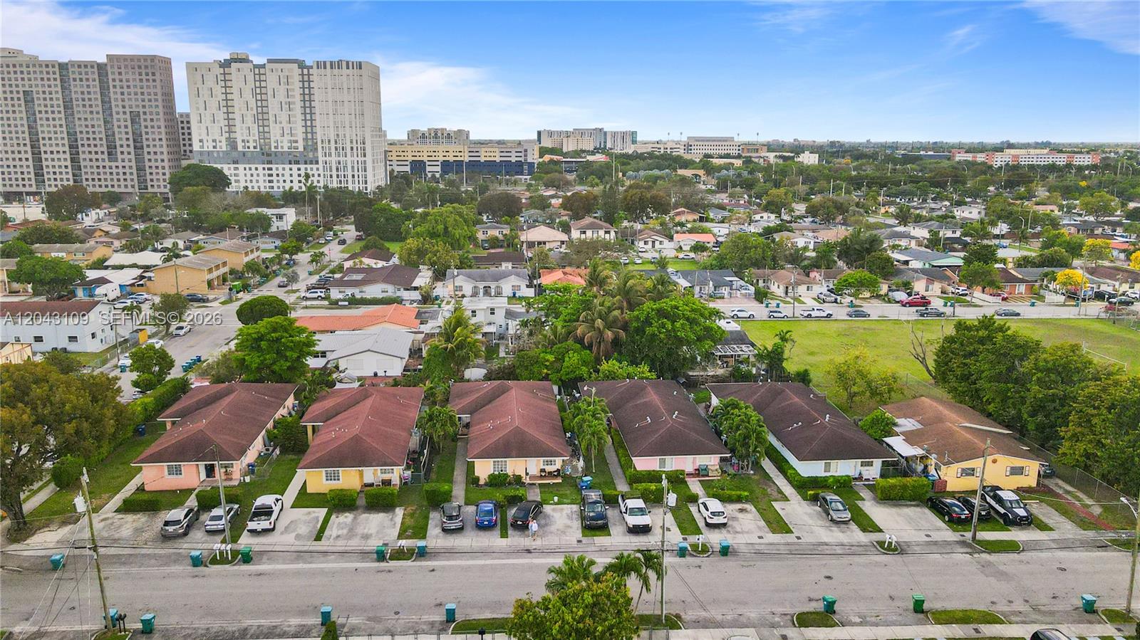 An aerial view shows a row of single-story houses with driveways facing a street — 11034 SW 3rd St, Sweetwater FL 33174, SWEETWATER, FL