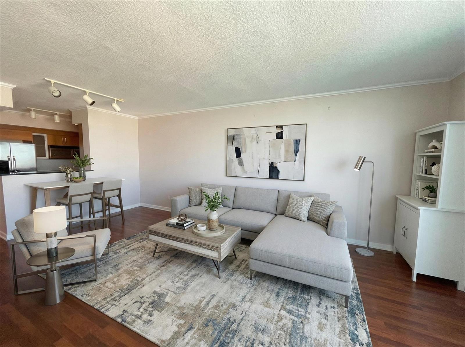 A living room features a grey sectional sofa, a coffee table, and an area rug — 335 S Biscayne Boulevard # 4004, Miami FL 33131, MIAMI, FL