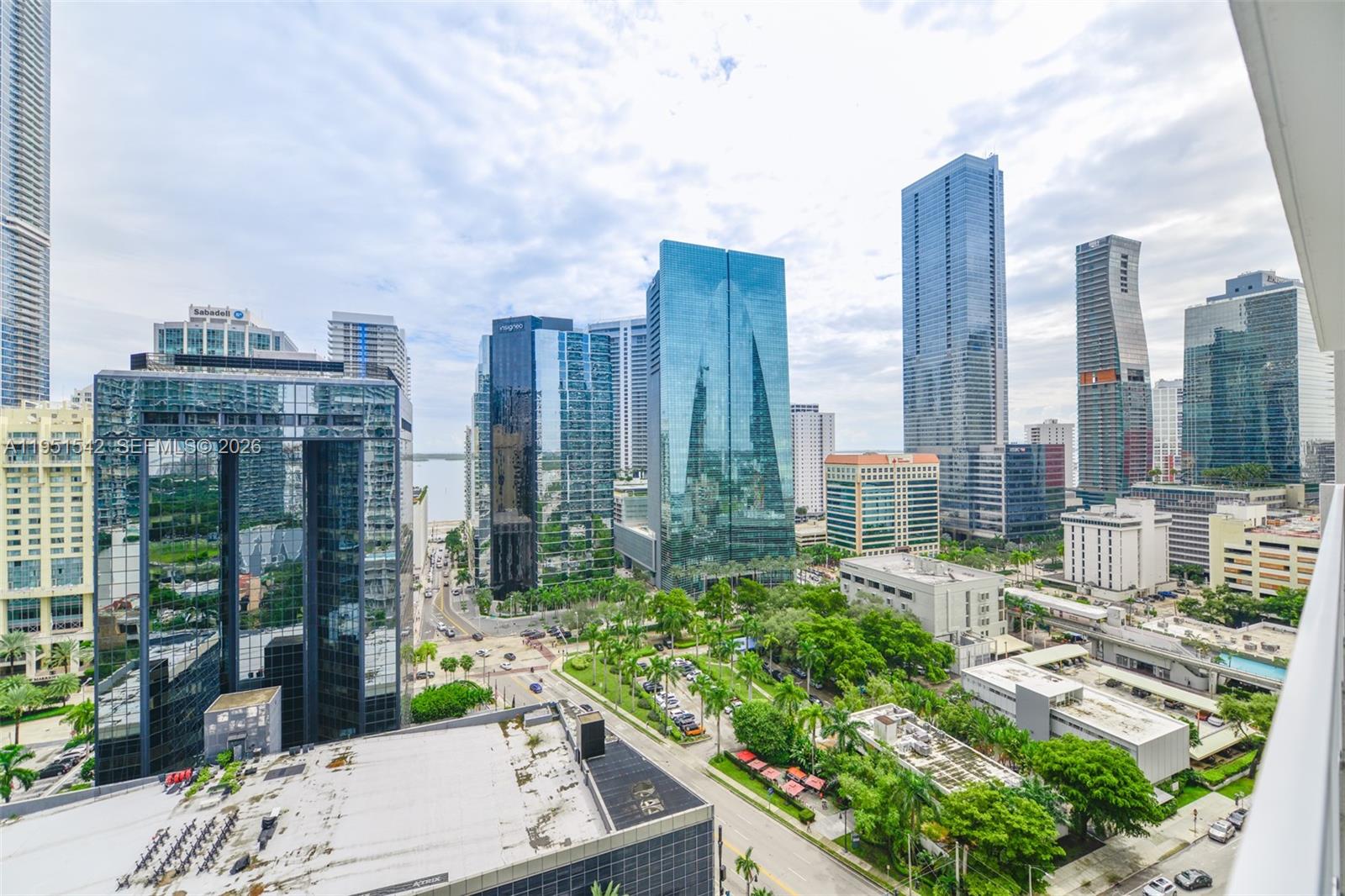 An elevated view of a dense urban skyline featuring modern glass skyscrapers and green trees — 1250 S Miami Ave # 1906, Miami FL 33130, MIAMI, FL