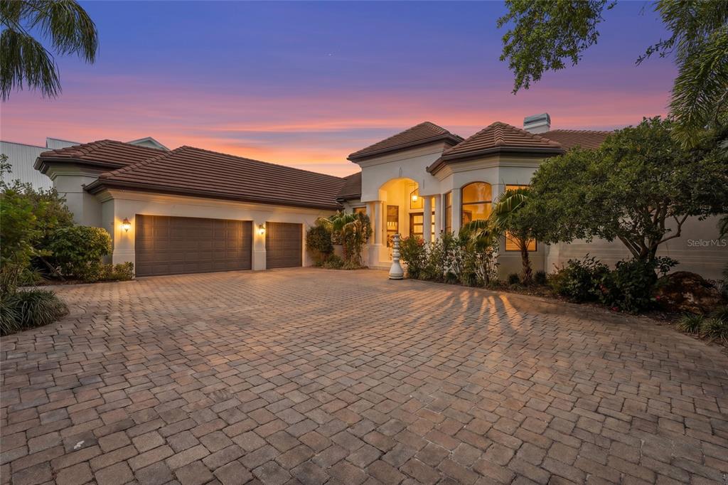 A single-story house with a tiled roof, a three-car garage, and a paved driveway — 7610 DESOTO MEMORIAL HIGHWAY, BRADENTON, FL