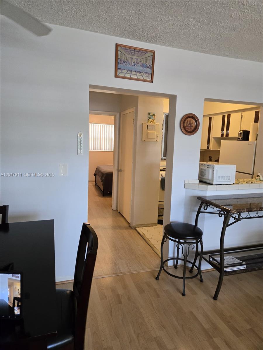 A view from a dining area looking through a doorway into a bedroom and kitchen — 2001 S Ocean Dr # 41, Hallandale Beach FL 33009, HALLANDALE BEACH, FL