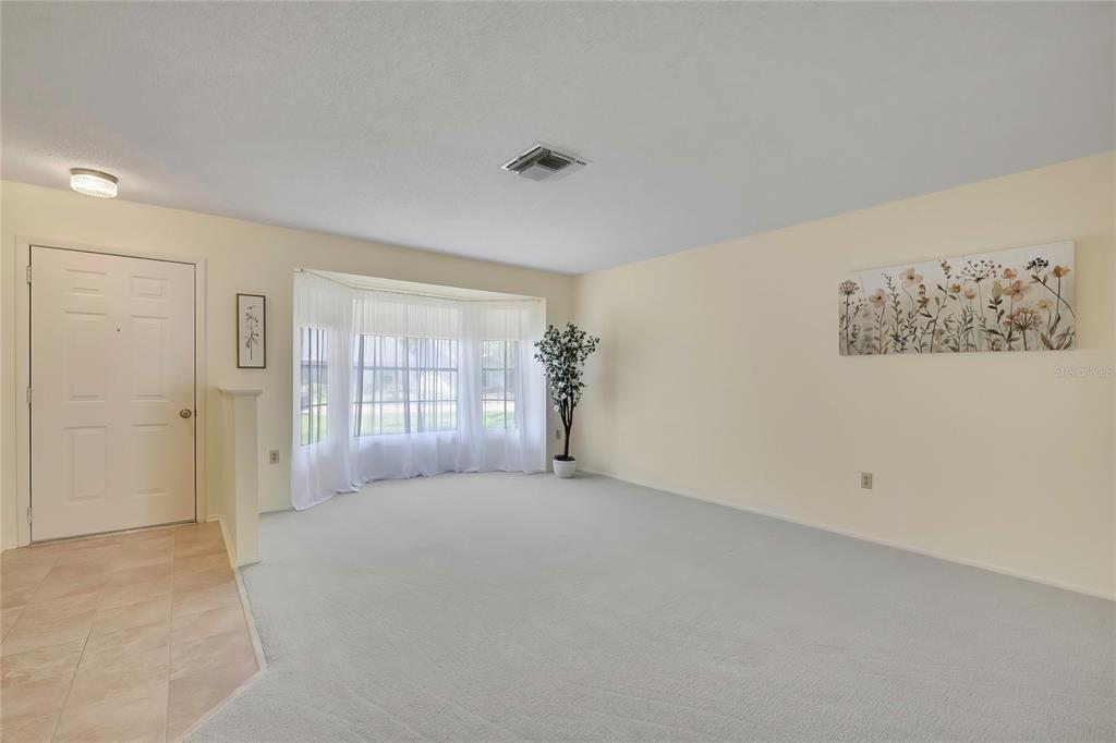 A single-story house with a brick facade, a two-car garage, and a front lawn — 7103 CROWN OAKS DRIVE, SPRING HILL, FL