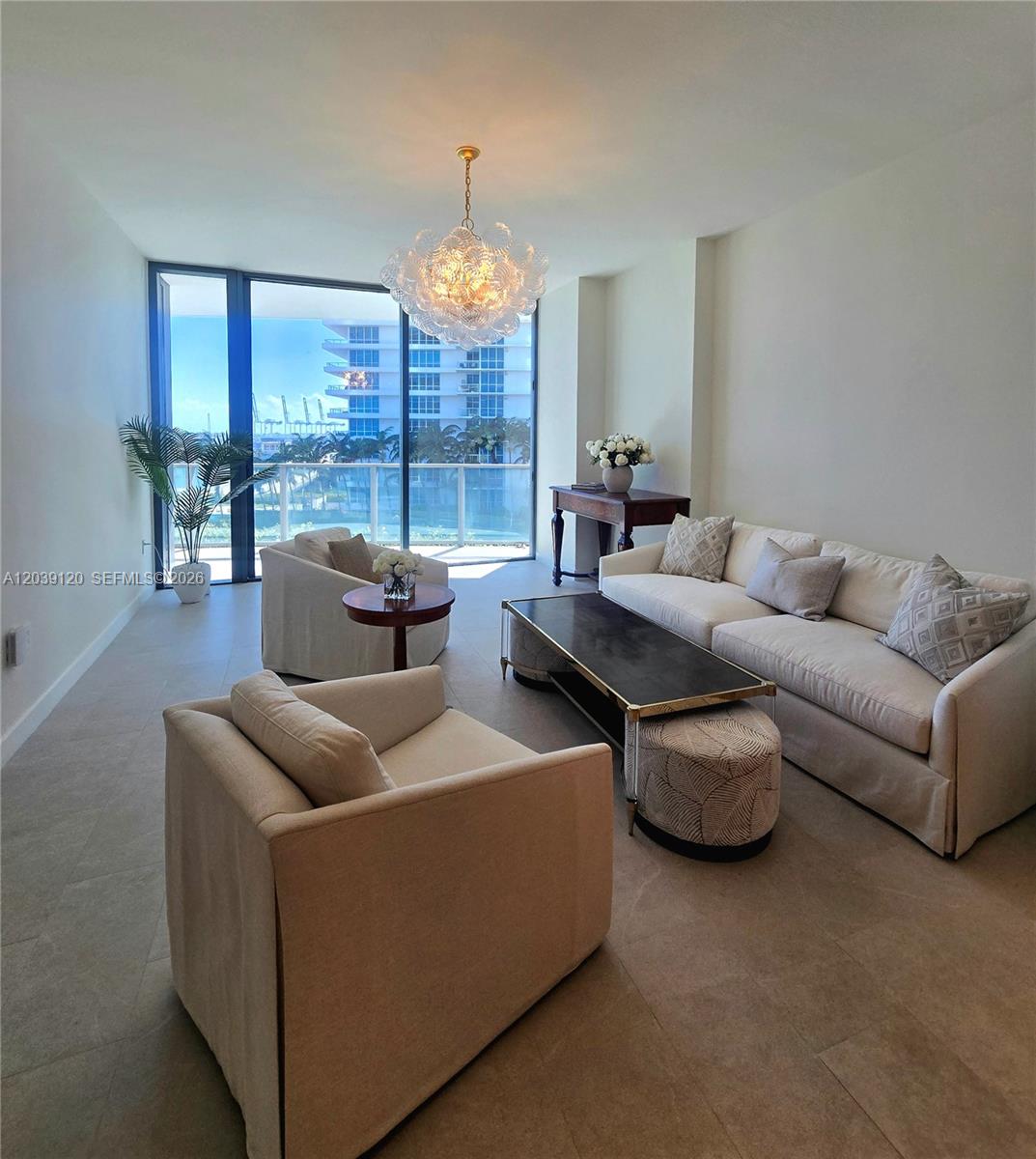 A living room features a sofa, two armchairs, a coffee table, and floor-to-ceiling windows — 500 Alton Rd # 904, Miami Beach FL 33139, MIAMI BEACH, FL