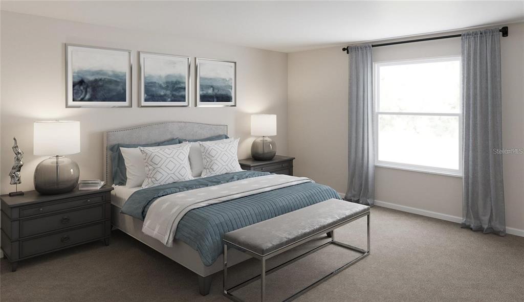 This bedroom features a bed with blue bedding, two nightstands, and a window with curtains — 33609 SKY BLOSSOM CIRCLE, LEESBURG, FL