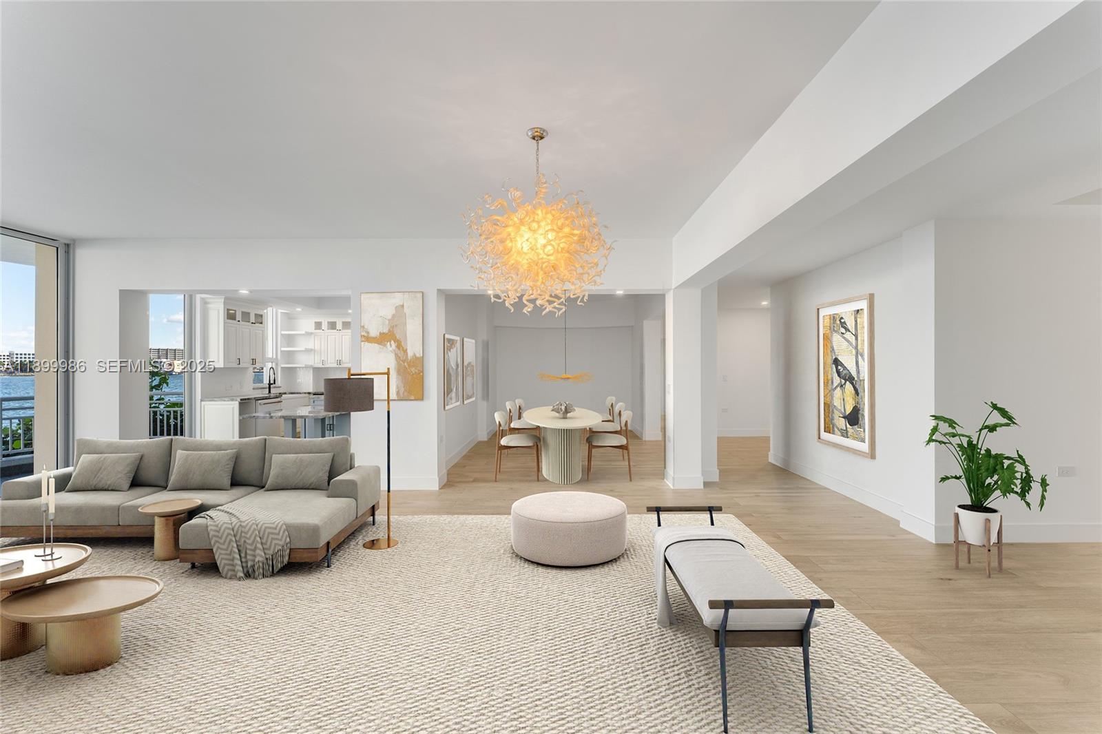 This open-concept living and dining area features light wood floors, modern furniture, and a chandelier — 848 Brickell Key Dr # 204, Miami FL 33131, MIAMI, FL