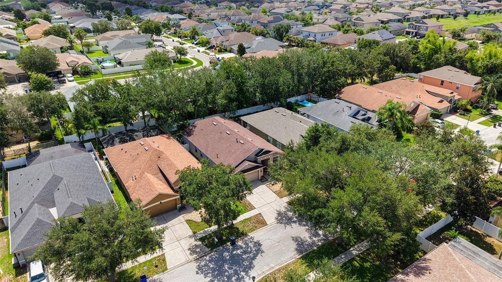 An aerial view shows several suburban houses with shingled roofs and driveways surrounded by trees — 13804 SIGLER STREET, RIVERVIEW, FL