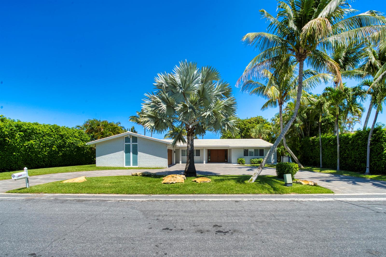 A single-story white brick house with a palm tree in the front yard — 2259 Ibis Isle Road E, Palm Beach FL 33480, PALM BEACH, FL