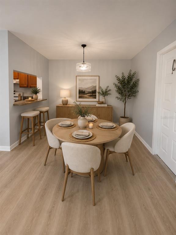 A dining room features a round wooden table, four upholstered chairs, and a kitchen pass-through — 1223 S PINE RIDGE CIRCLE UNIT 23, SANFORD, FL