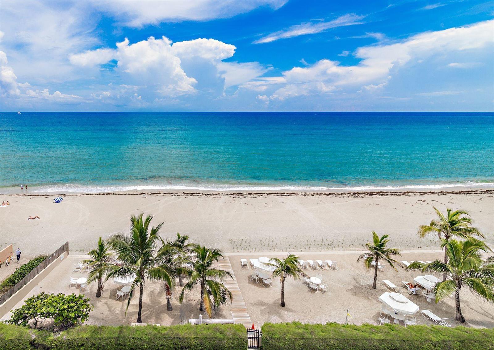 An aerial view of a sandy beach with palm trees and lounge chairs by the ocean — 170 N Ocean Boulevard # 409, Palm Beach FL 33480, PALM BEACH, FL
