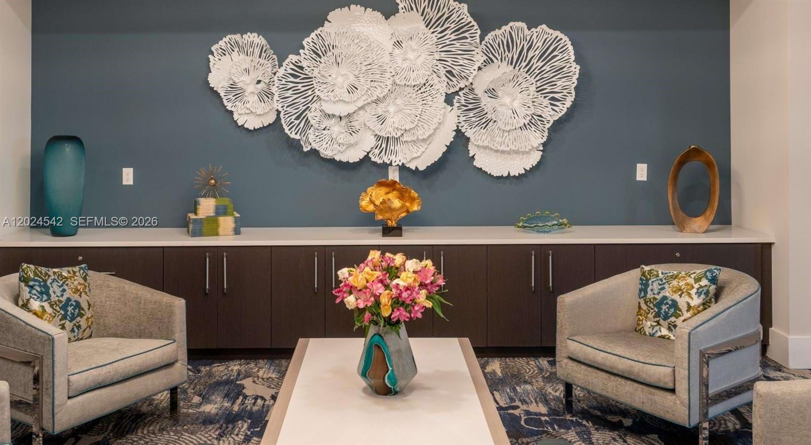 A seating area features two armchairs, a coffee table with flowers, and wall-mounted art — 4720 NW 85th Ave, Doral FL 33166, DORAL, FL