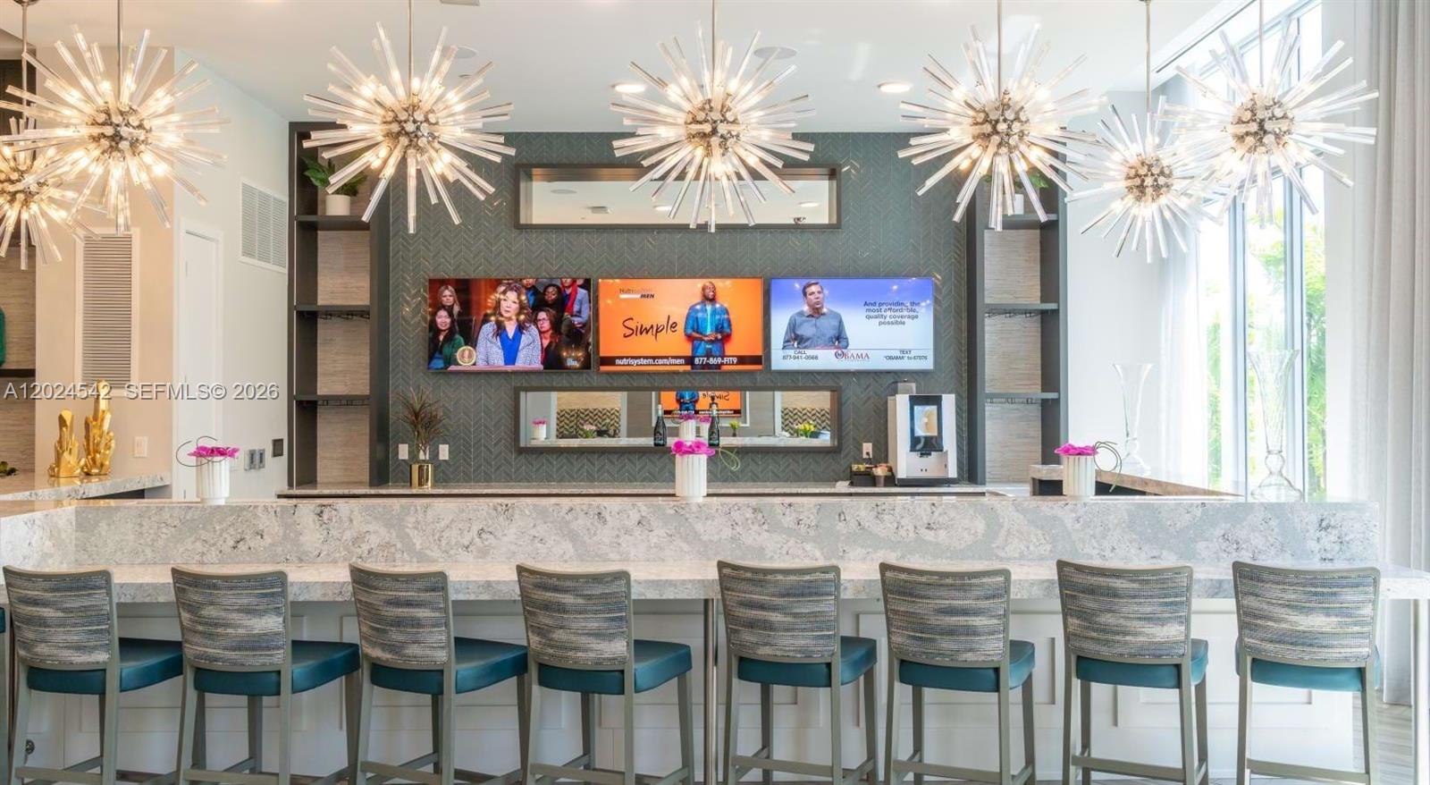 A modern bar area features a long stone counter, six upholstered chairs, and three wall-mounted televisions — 4720 NW 85th Ave, Doral FL 33166, DORAL, FL