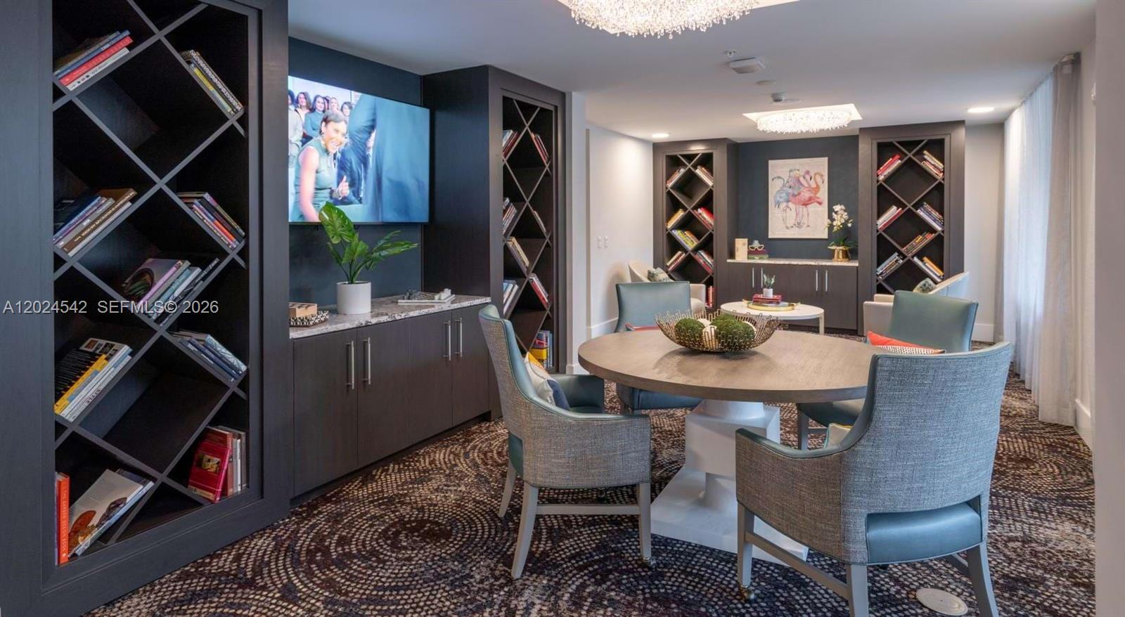 A lounge area features a round table, upholstered chairs, dark built-in shelving, and patterned carpeting — 4720 NW 85th Ave, Doral FL 33166, DORAL, FL