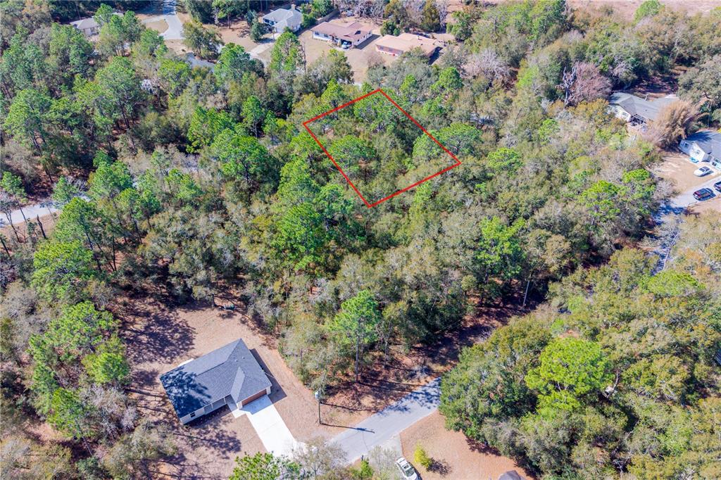 An aerial view shows a wooded residential lot outlined in red near a house — TBD NE 1ST PL, LOT 6, WILLISTON, FL