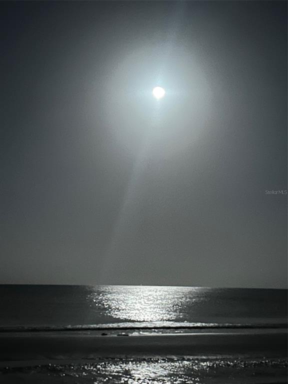 A bright moon shines over a dark ocean at night with reflections on the water — 18218 SUNSET BOULEVARD UNIT A, ST PETERSBURG, FL