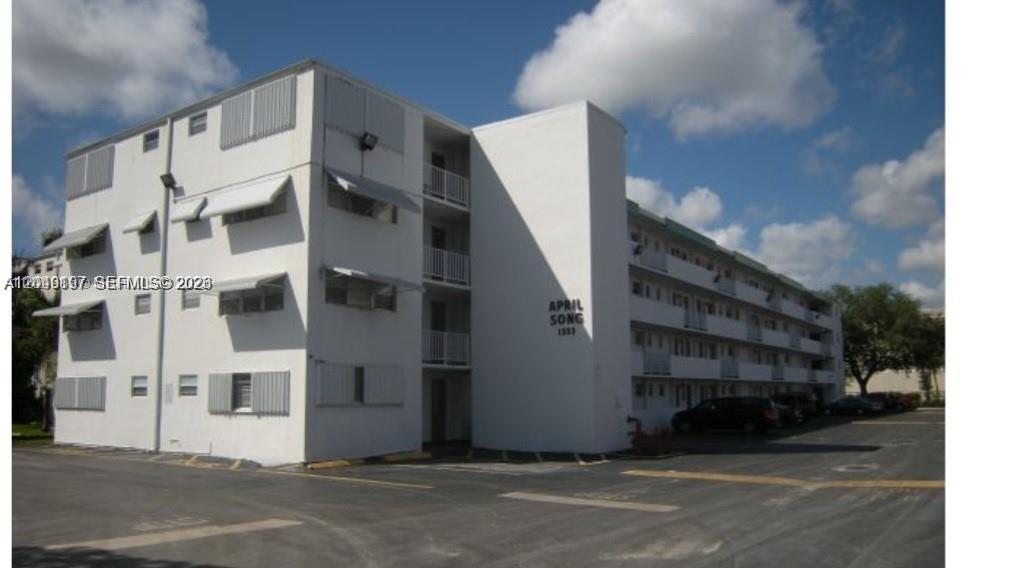A three-story white apartment building with exterior walkways and a parking lot in front — 1333 E Hallandale Beach Blvd # 329, Hallandale Beach FL 33009, HALLANDALE BEACH, FL