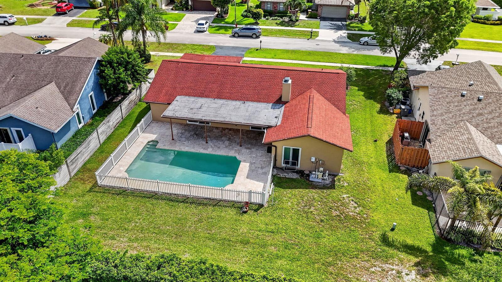 An aerial view shows a house with a red roof, a pool, and a patio — 20876 Sugarloaf Lane, Boca Raton FL 33428, BOCA RATON, FL