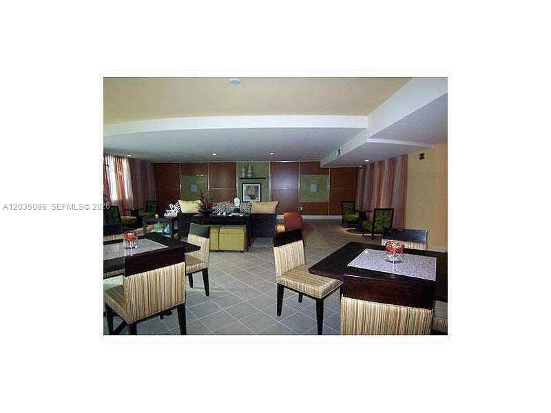 A lounge area features dining tables, chairs, and a seating area with wood paneling — 7350 SW 89th St # 505S, Miami FL 33156, MIAMI, FL