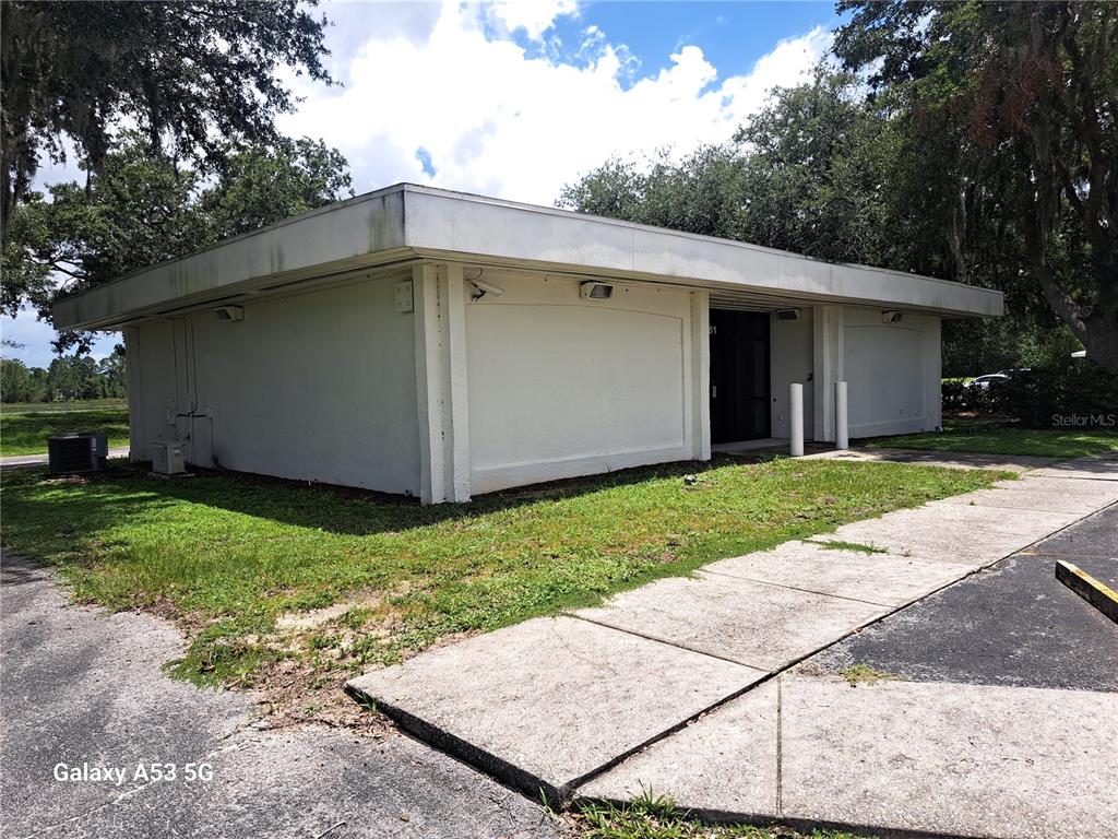 A single-story commercial building with a flat roof and white exterior walls — 6481 DELAND AVENUE, INDIAN LAKE ESTATES, FL