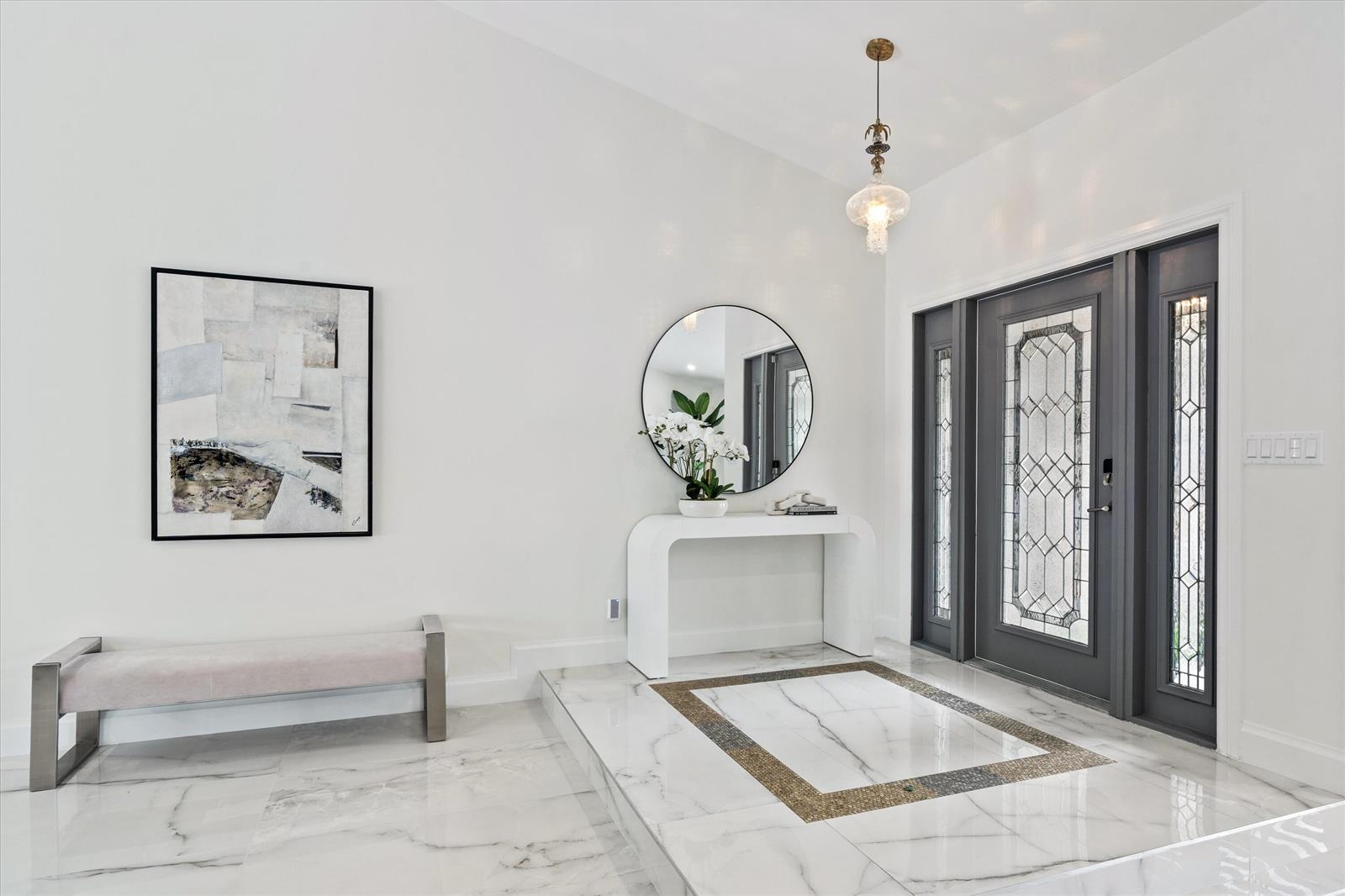 A bright entryway features a marble floor, a console table, a mirror, and a bench — 2069 SW 7th Court, Boca Raton FL 33486, BOCA RATON, FL