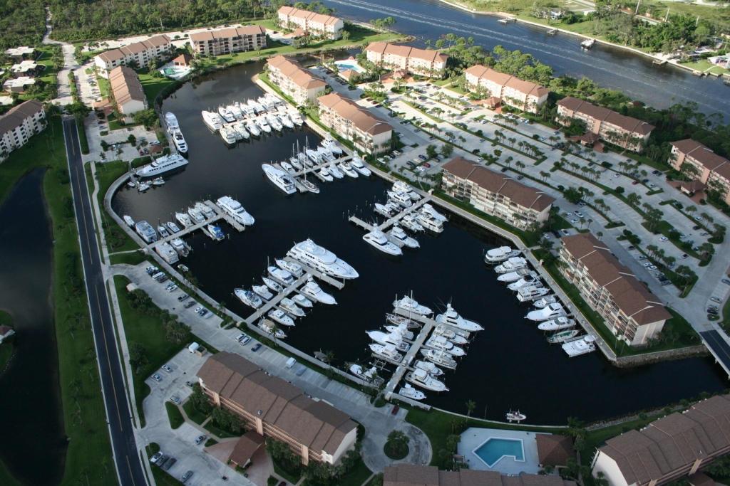An aerial view of a residential complex with a marina filled with boats and swimming pools — 1320 Tidal Pointe Boulevard, Jupiter FL 33477, JUPITER, FL