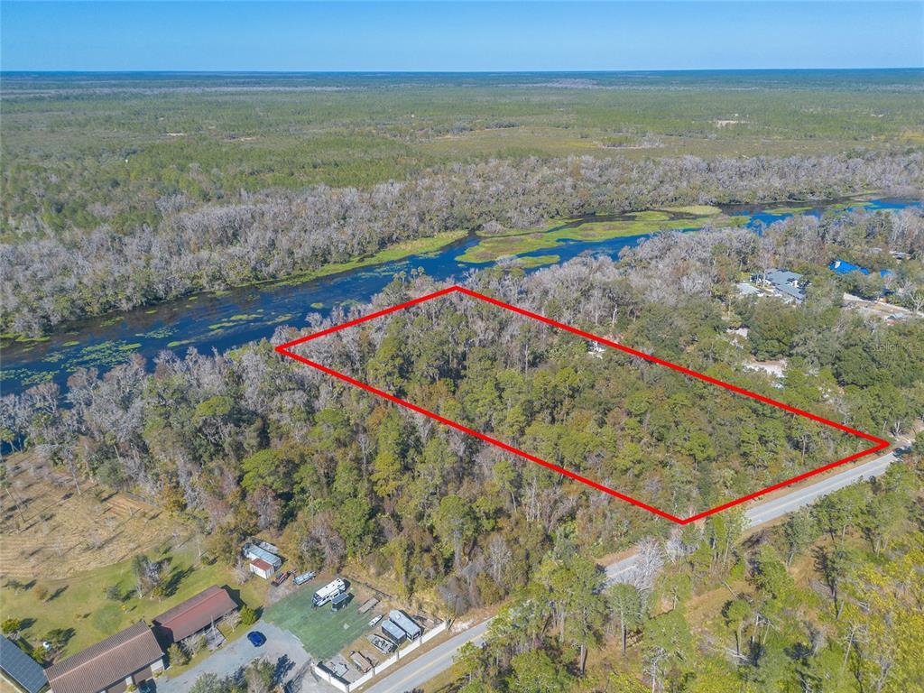An aerial view shows a rectangular wooded lot outlined in red next to a river — 178 WEKIVA PARK DRIVE, SANFORD, FL