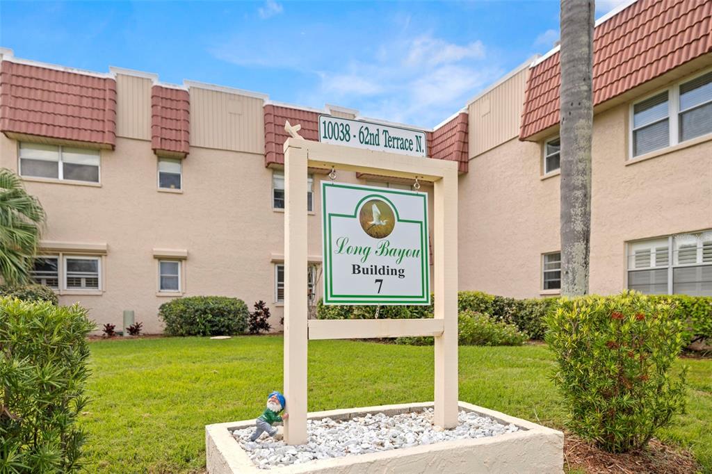 A sign for Long Bayou Building 7 stands in front of a multi-story apartment complex — 10038 62ND TERRACE N UNIT 1, ST PETERSBURG, FL